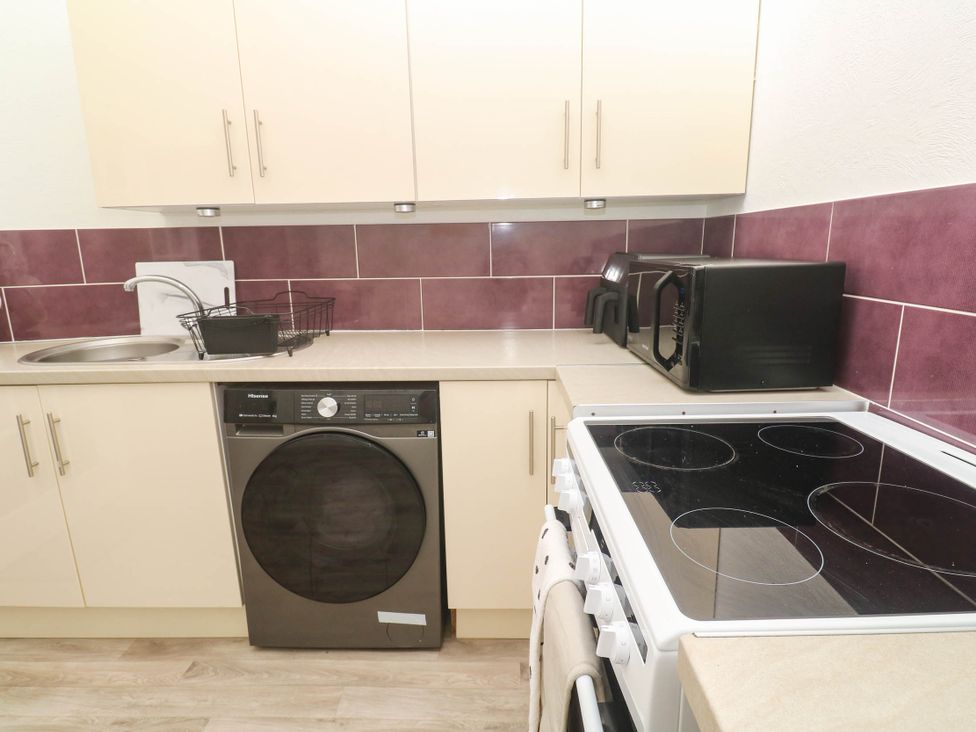 A kitchen with appliances and a sink at Flat 2 in Penzance