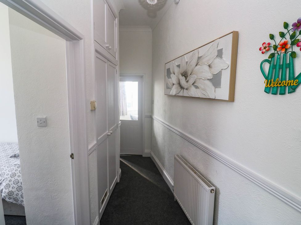 A hallway with cabinets and a window at Flat 2 in Penzance