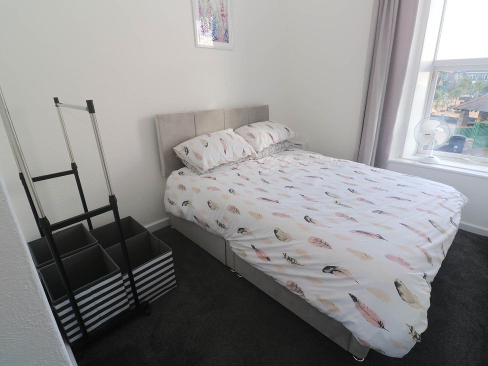 A bedroom with a bed and storage boxes at Flat 2 in Penzance