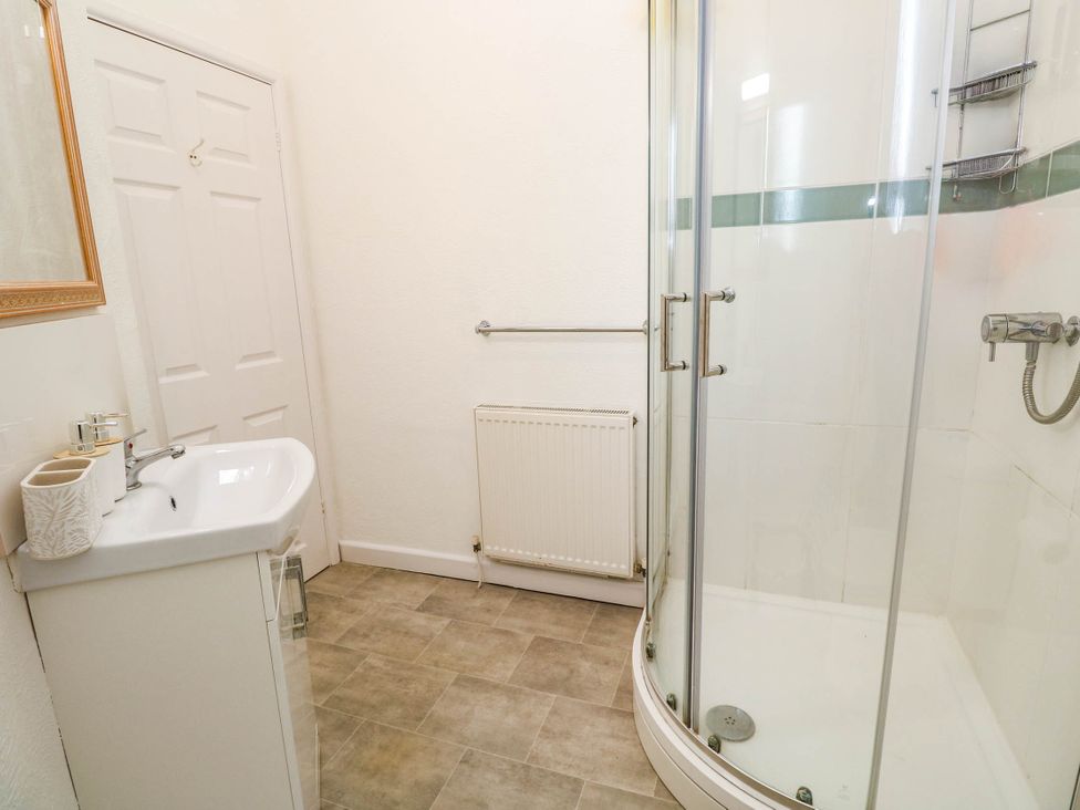 A bathroom with a shower and washbasin at Flat 2 in Penzance