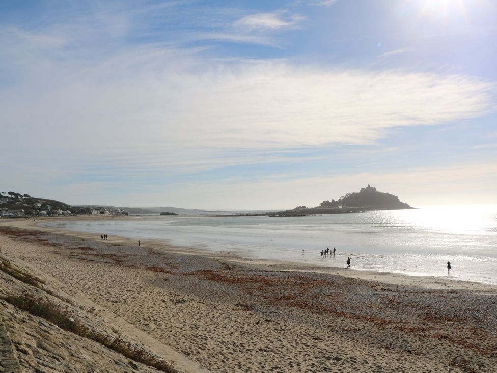 A beach with water and people at Seafront Soliel in Penzance