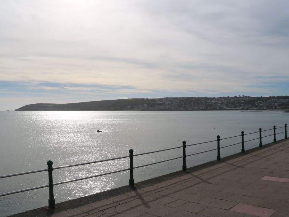 A view of the ocean with a fishing boat at Seafront Soliel in Penzance