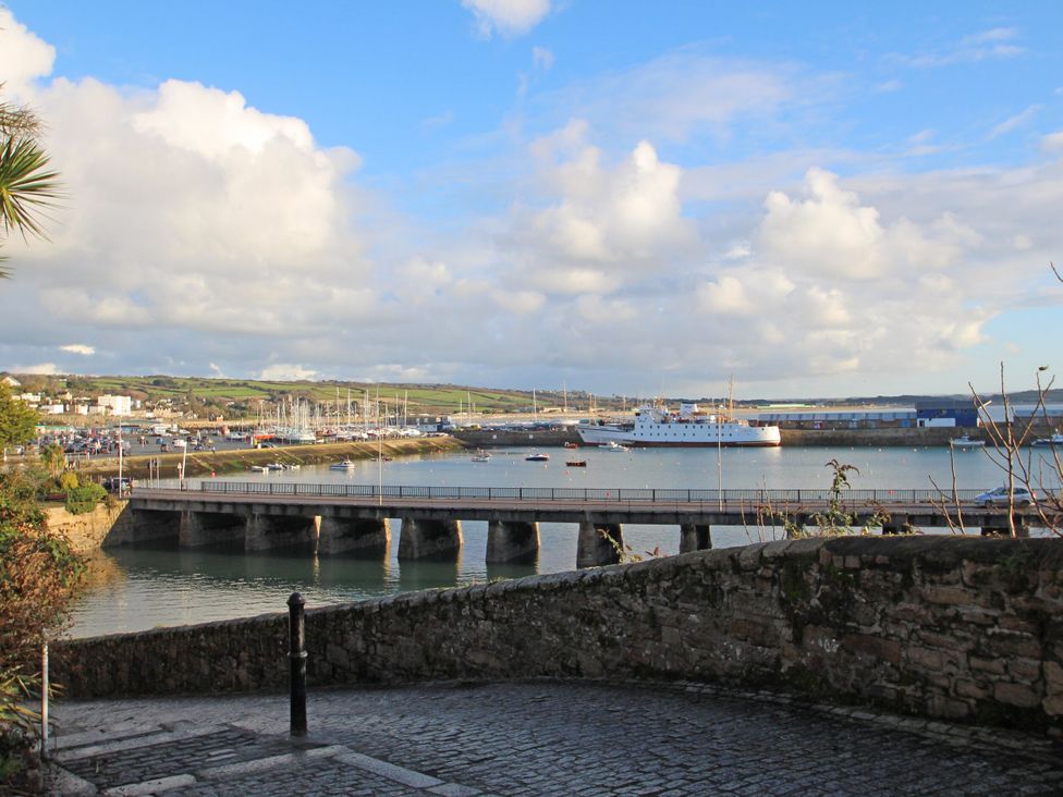 A scenic view of a harbor with boats and a bridge at Seafront Soliel in Penzance