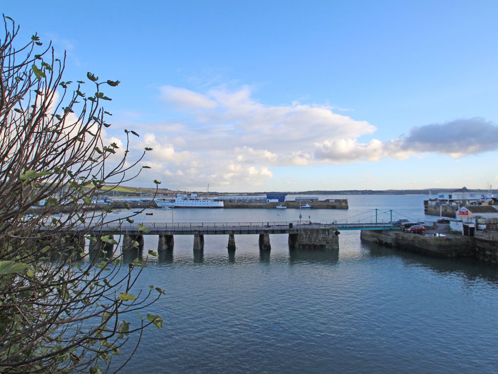 A pier with boats in the water at Seafront Soliel in Penzance