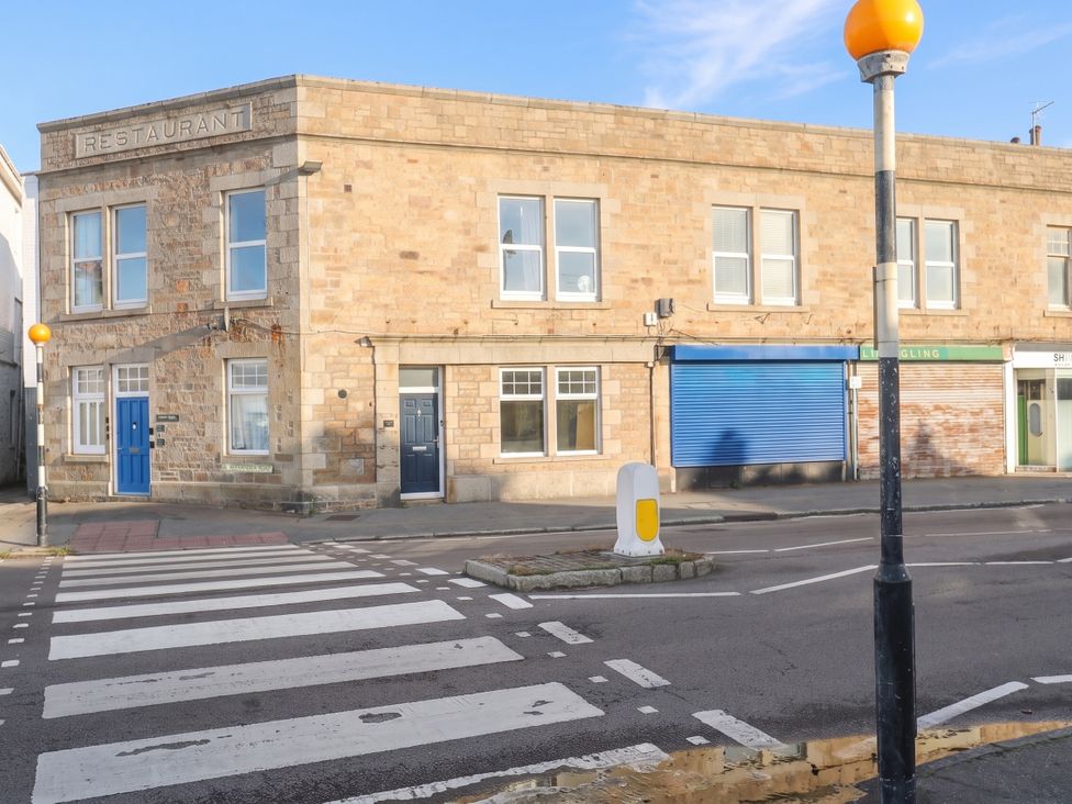 A restaurant building with several windows and doors in Penzance