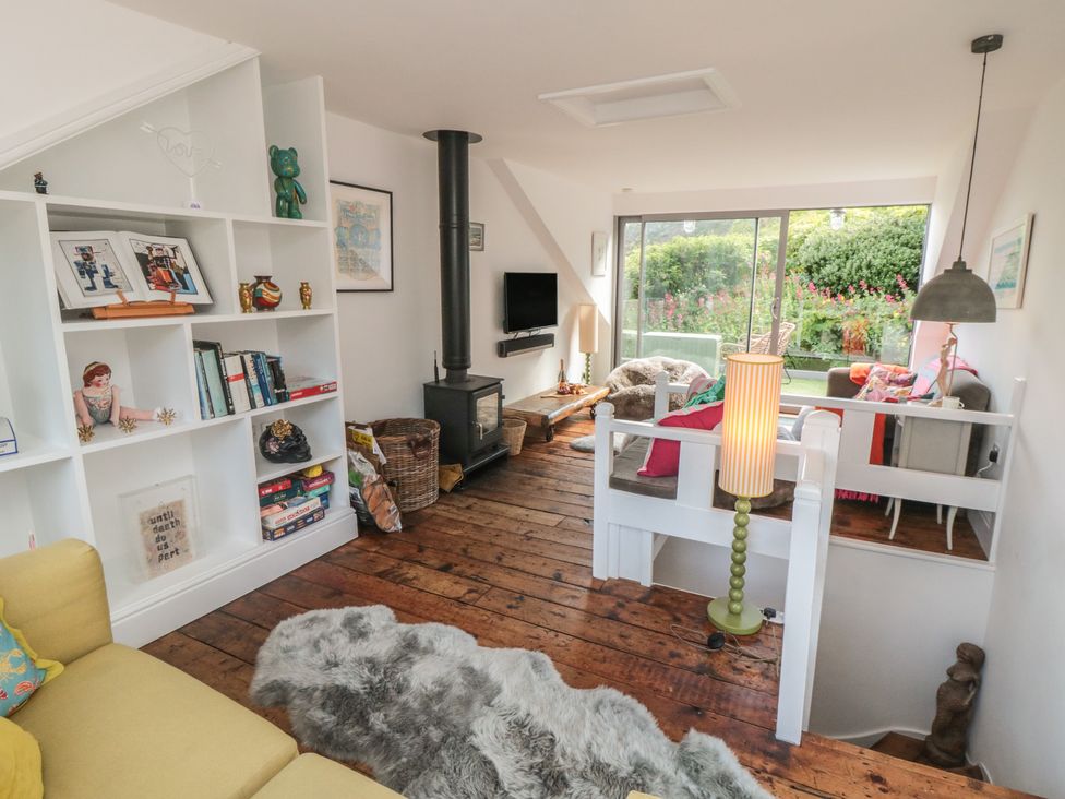 A living room with a fireplace and a bookshelf at Hillsover in Saltburn-by-the-Sea