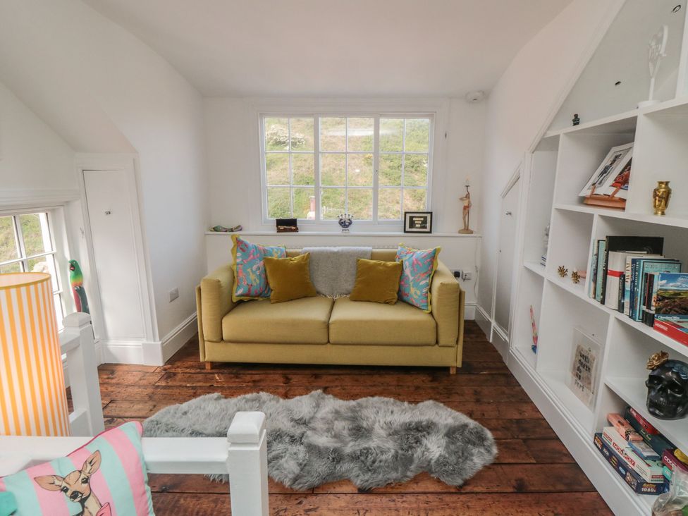 A living room with a sofa and shelves at Hillsover in Saltburn-by-the-Sea