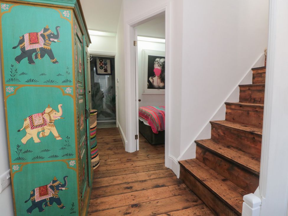 A hallway with a wardrobe and staircase at Hillsover in Saltburn-by-the-Sea