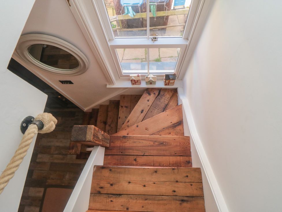 A staircase with wooden steps and a mirror at Hillsover in Saltburn-by-the-Sea