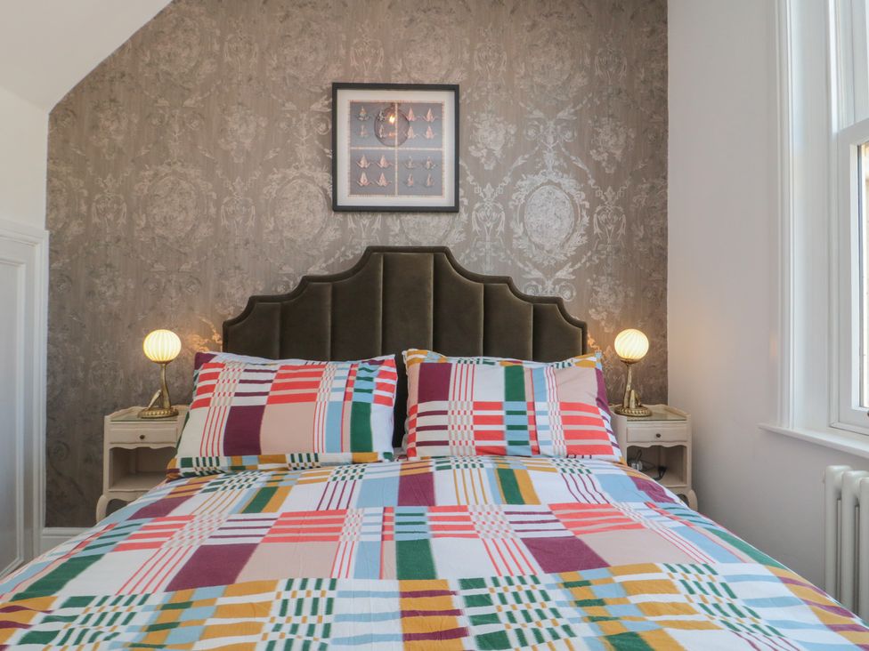 A bedroom with a bed and bedside tables at Hillsover in Saltburn-by-the-Sea