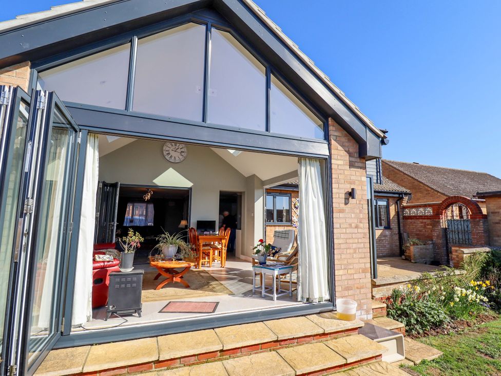 A living room with a dining table and chairs at Seascape in Hunstanton