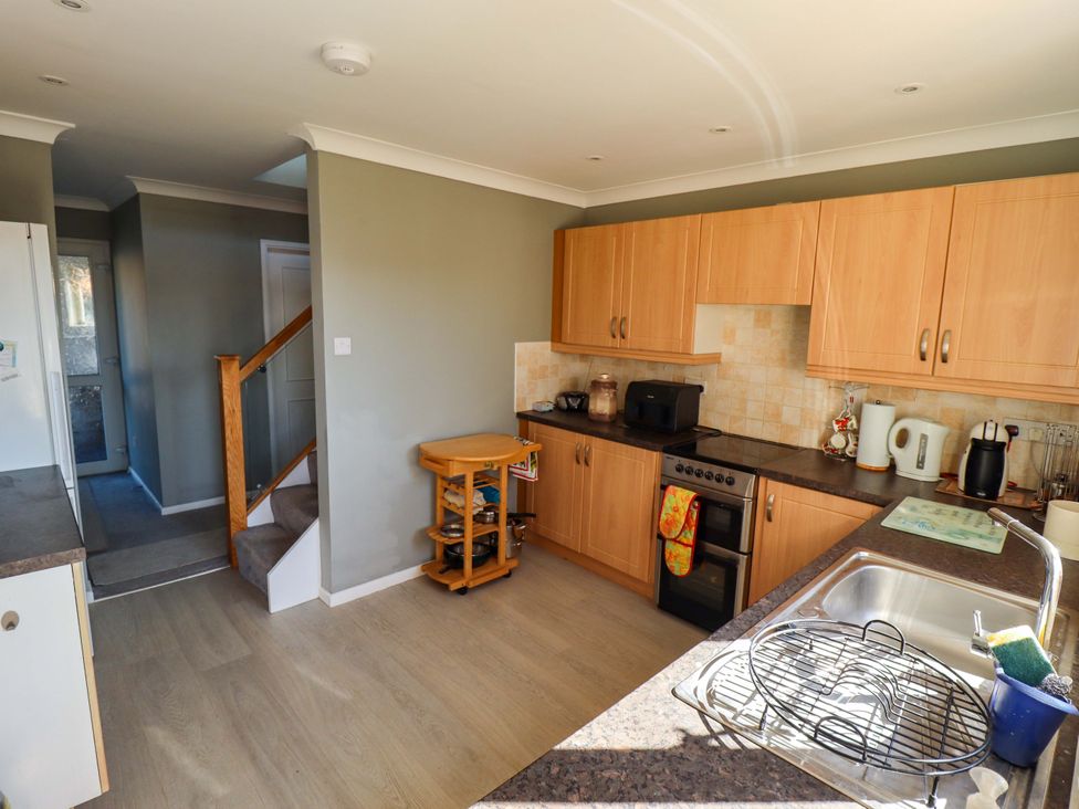 A kitchen with cabinets and appliances at Seascape in Hunstanton
