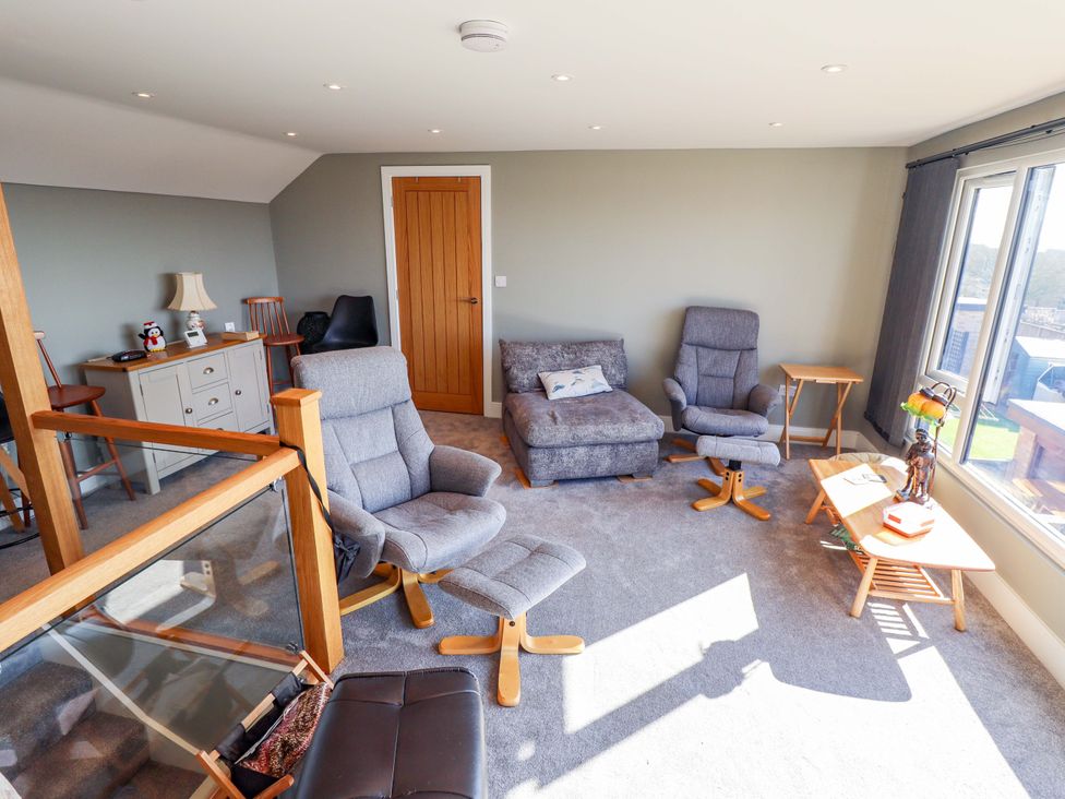 A living room with chairs and a sofa at Seascape in Hunstanton