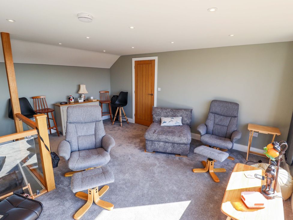 A living room with chairs and a sofa at Seascape in Hunstanton