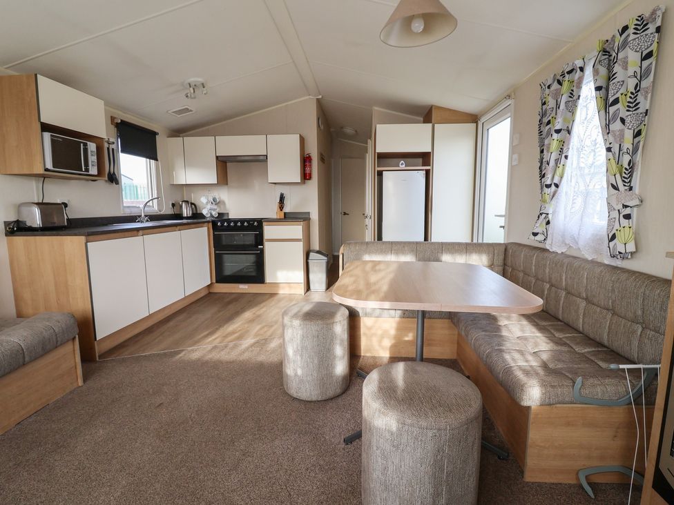 A kitchen with appliances and seating area at Away Resorts - Golden Sands Holiday Park, Rhyl