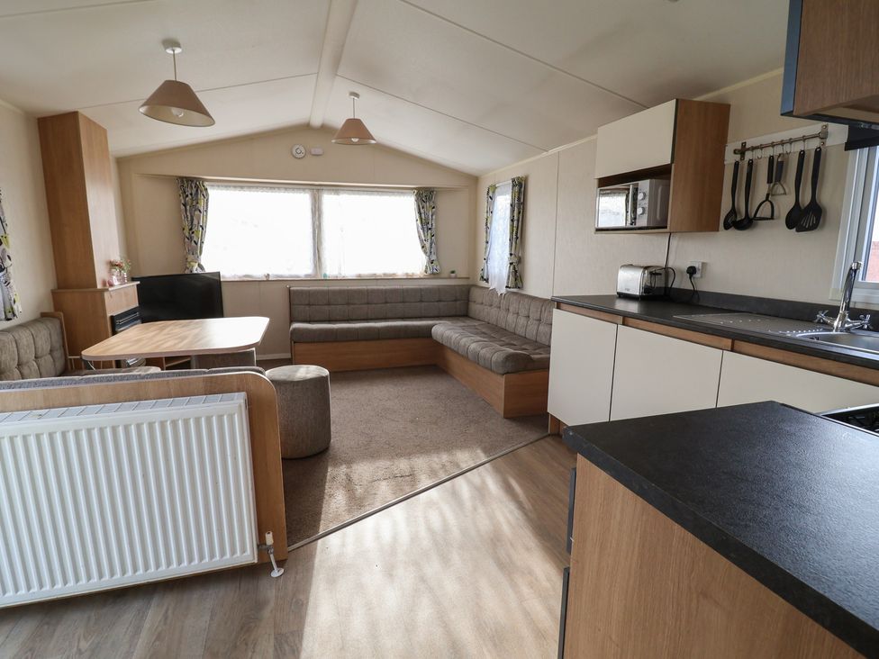 A living room with a sofa and table at Away Resorts - Golden Sands Holiday Park, Rhyl