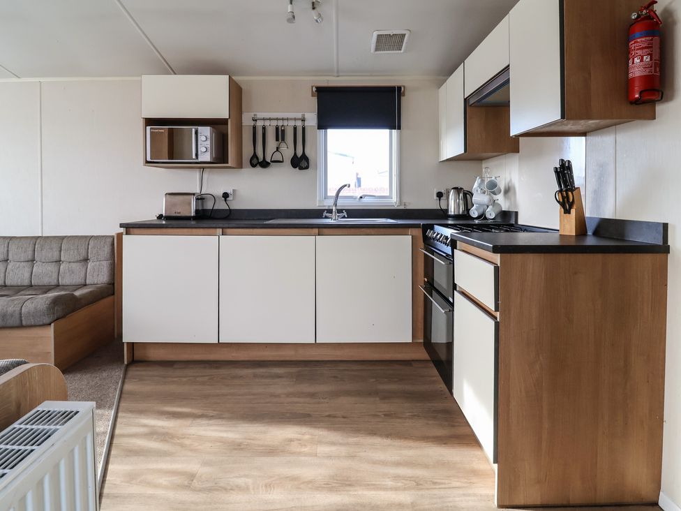 A kitchen with cabinets and appliances at Away Resorts - Golden Sands Holiday Park, Rhyl