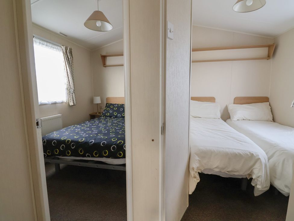 A bedroom with a double bed and a single bed at Away Resorts - Golden Sands Holiday Park,  C in Rhyl
