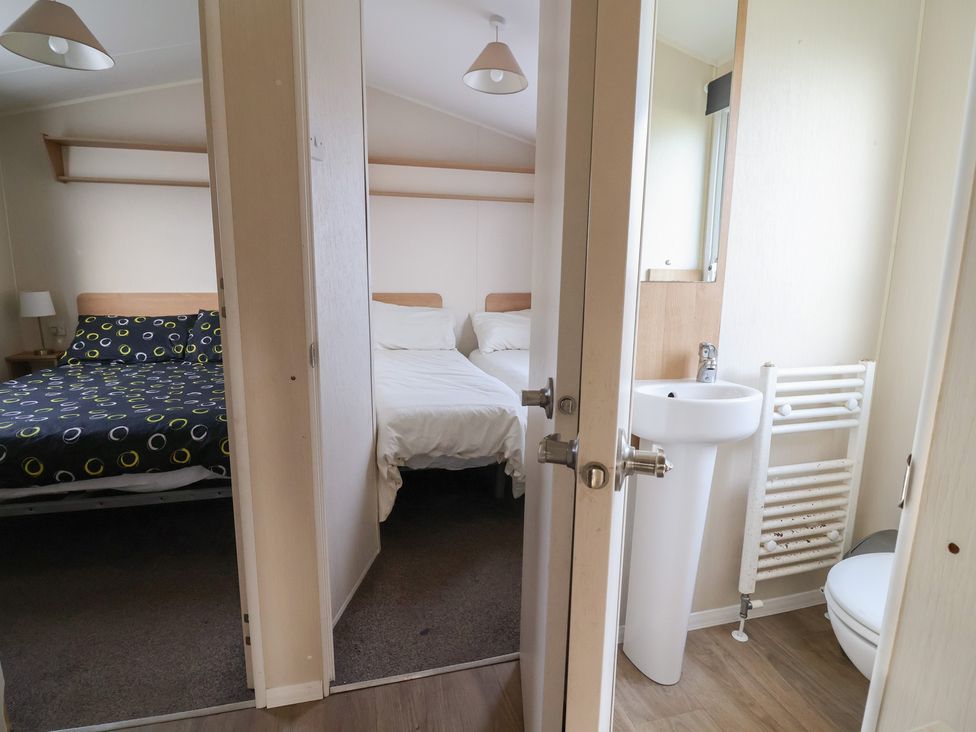 A bedroom with a double and single bed at Away Resorts - Golden Sands Holiday Park, Rhyl