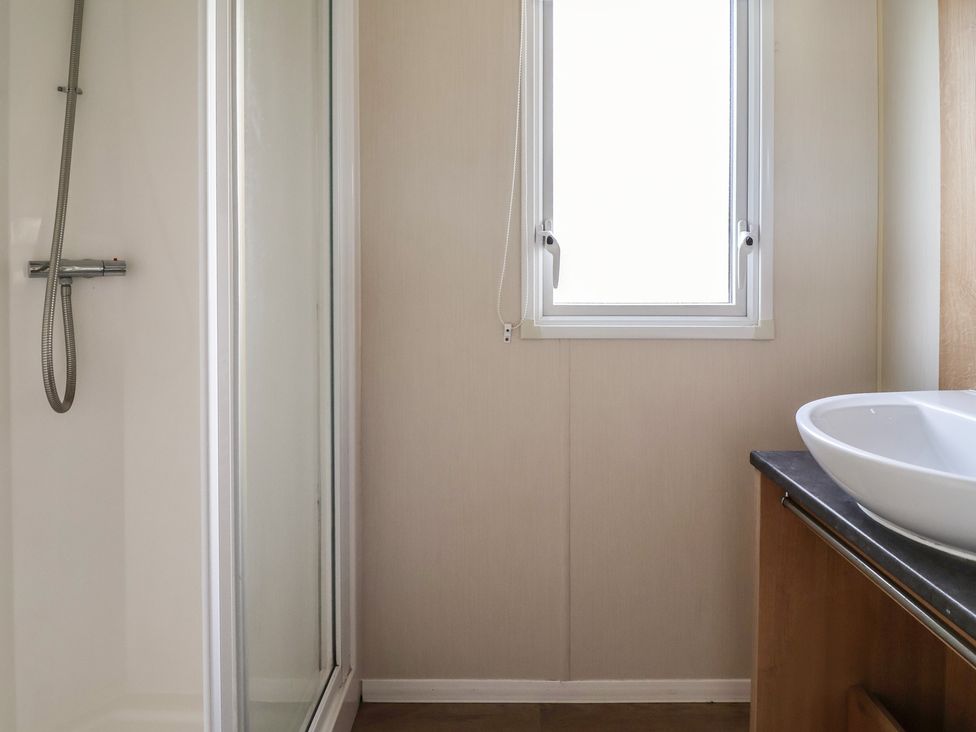 A bathroom with a shower and sink at Away Resorts - Golden Sands Holiday Park,  C Rhyl