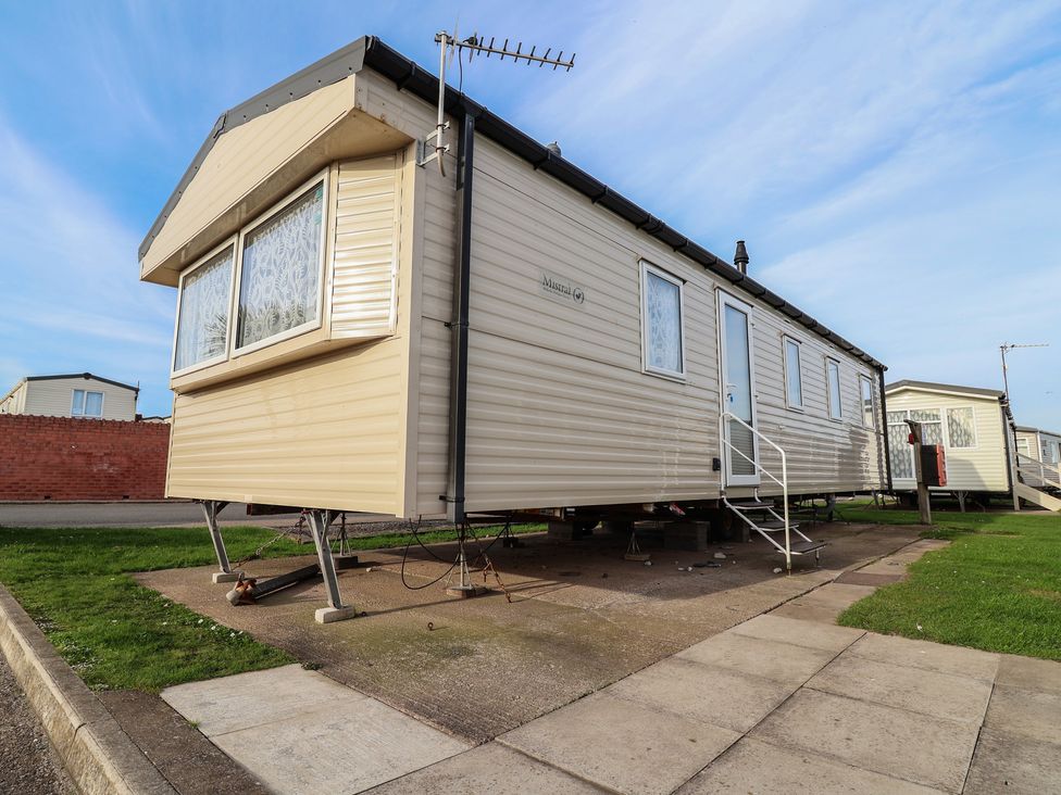 A caravan on a concrete pavement at Away Resorts - Golden Sands Holiday Park, Rhyl