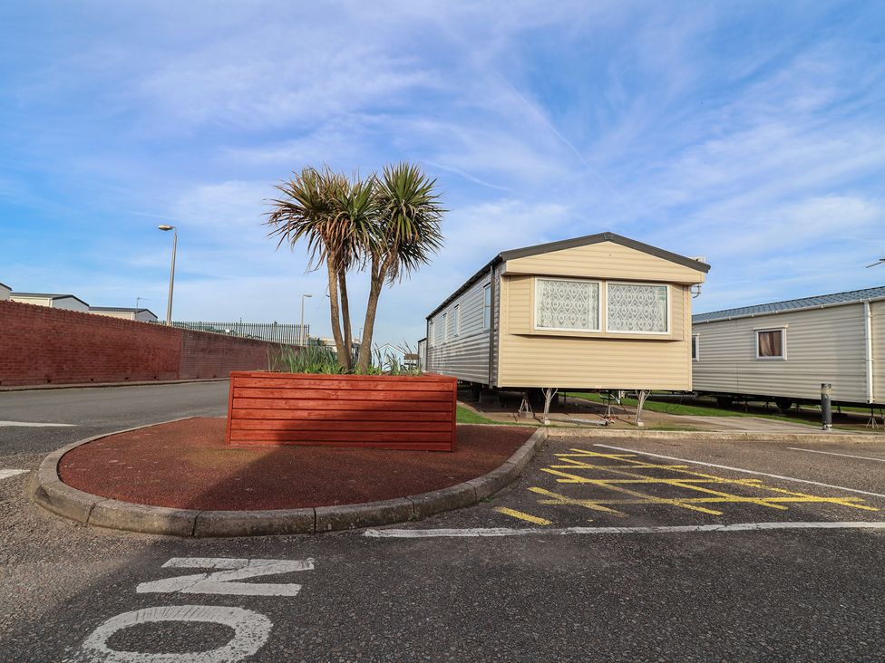 A caravan parked next to a palm tree at Away Resorts - Golden Sands Holiday Park, Rhyl