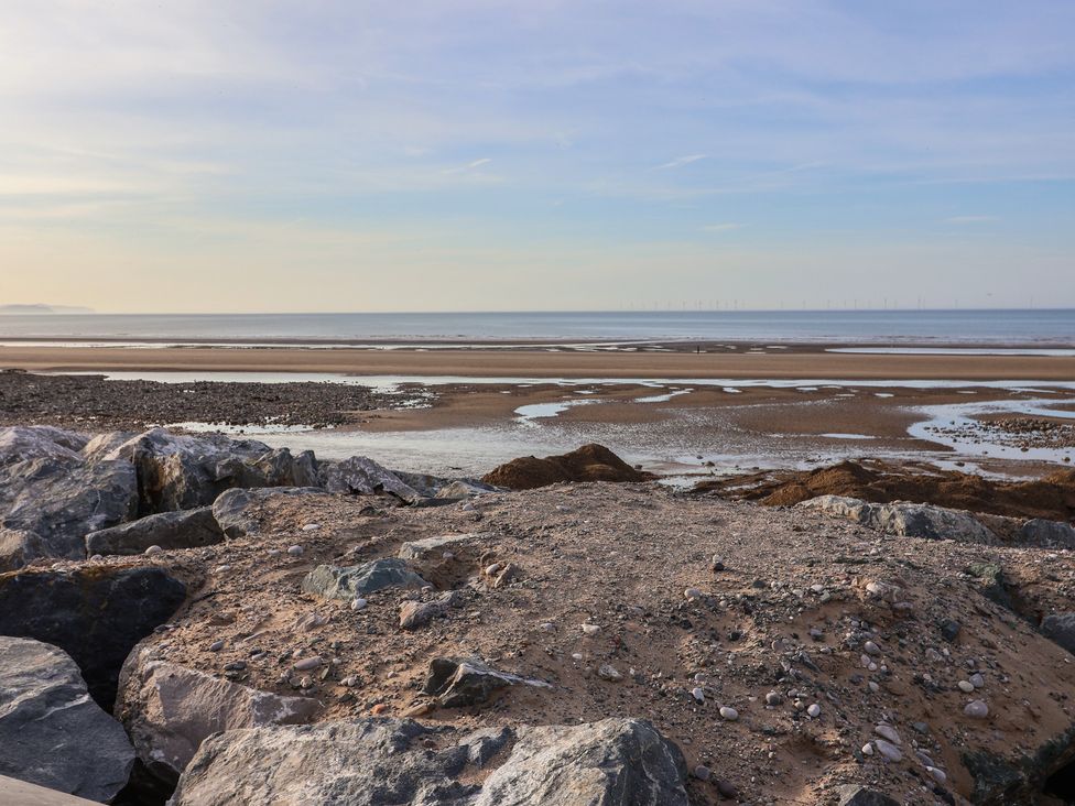 A beach with sand and rocks at Away Resorts - Golden Sands Holiday Park, Rhyl