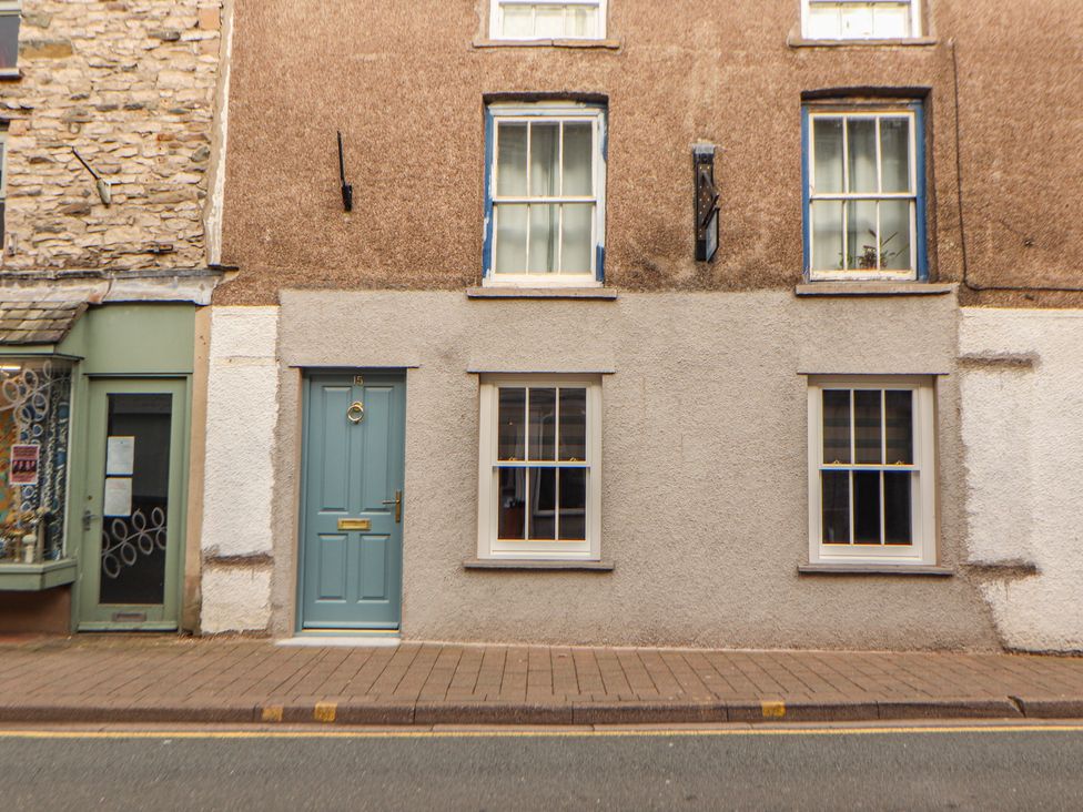 A building facade with a blue door and windows at The Old Bakehouse Kendal