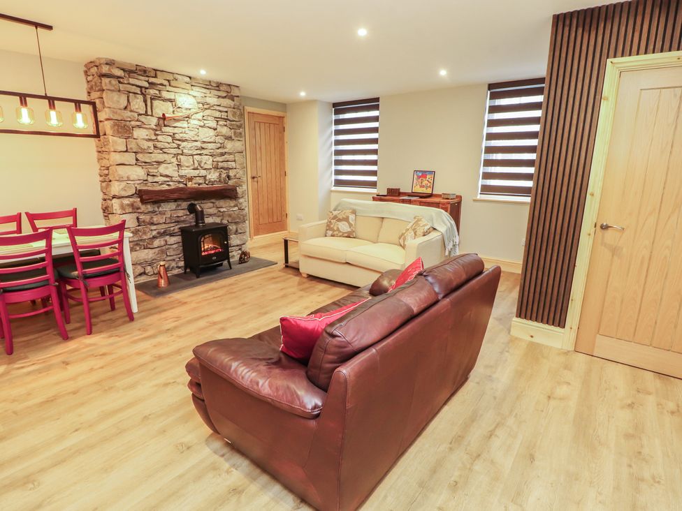 A living room with a sofa and dining table at The Old Bakehouse in Kendal