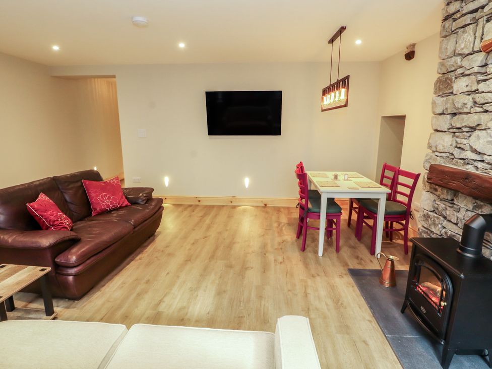 A living room with a sofa and dining table at The Old Bakehouse in Kendal