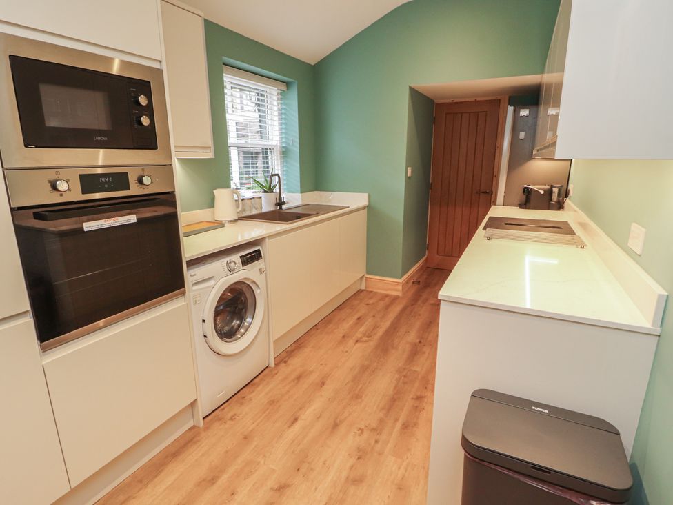 A kitchen with appliances and sink at The Old Bakehouse Kendal