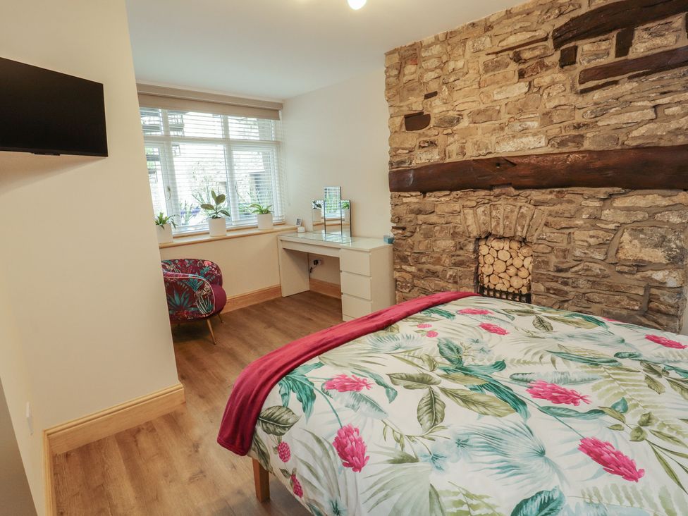 A bedroom with a bed and desk at The Old Bakehouse in Kendal