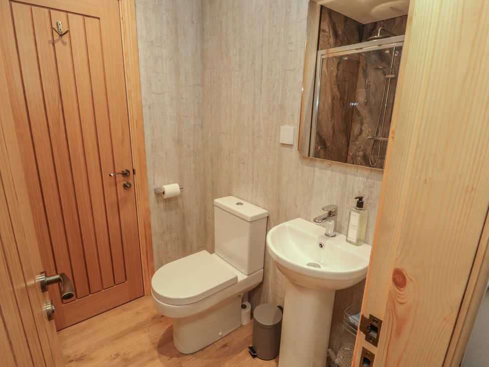 A bathroom with a toilet and sink at The Old Bakehouse in Kendal