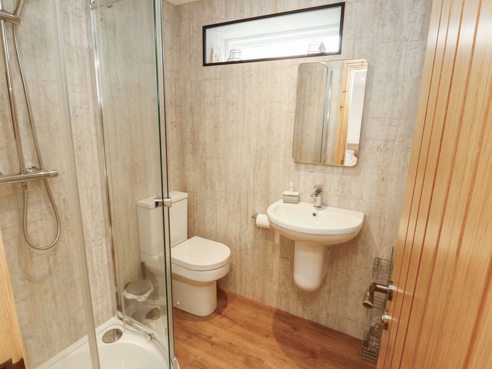A bathroom with a shower and sink at The Old Bakehouse in Kendal
