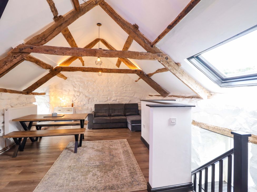 A living room with a sofa and table at The Lodge House at Rhiw Goch Inn Snowdonia National Park