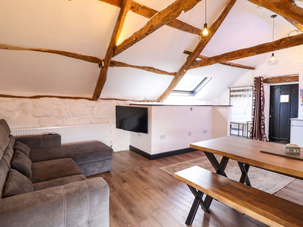A living room with a sofa and a television at The Lodge House at Rhiw Goch Inn in Snowdonia National Park