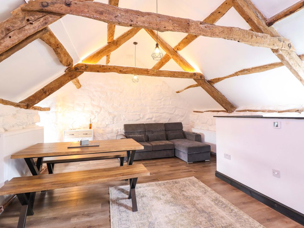 A living room with a dining table and sofa at The Lodge House at Rhiw Goch Inn, Snowdonia National Park