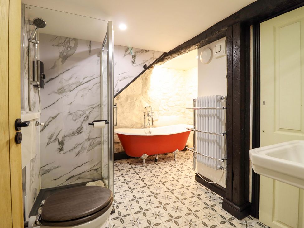 A bathroom with a shower, bathtub, and toilet at The Lodge House at Rhiw Goch Inn Snowdonia National Park