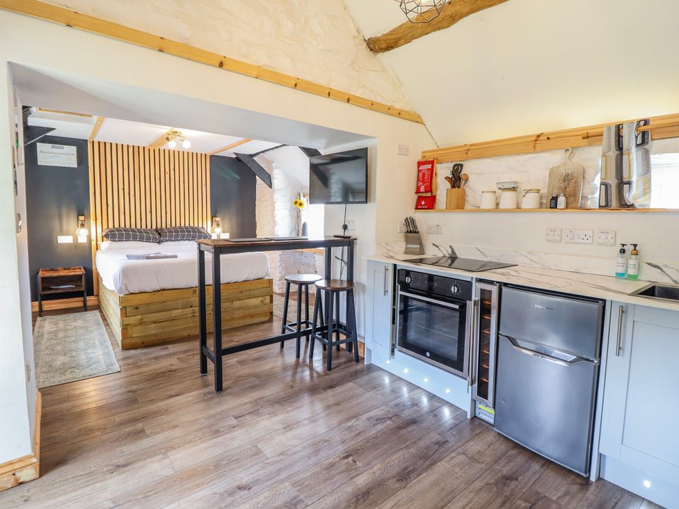 A kitchen with a dining area and sleeping area at The Romantic Hideaway at Rhiw Goch Inn, Snowdonia National Park