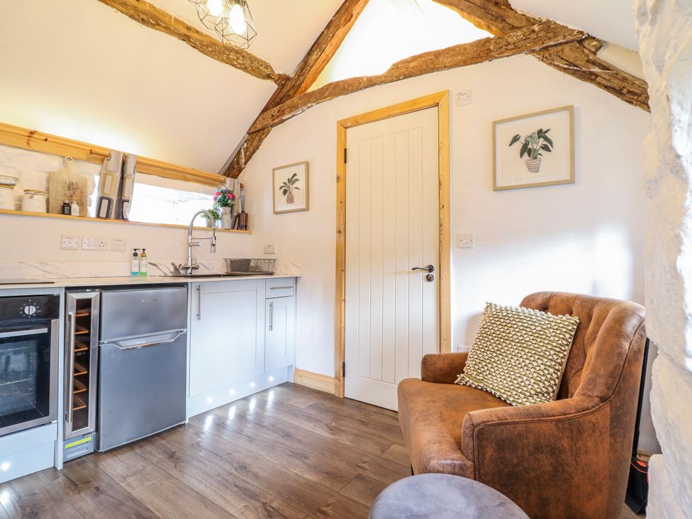 A kitchen featuring various appliances and a chair at The Romantic Hideaway at Rhiw Goch Inn Snowdonia National Park
