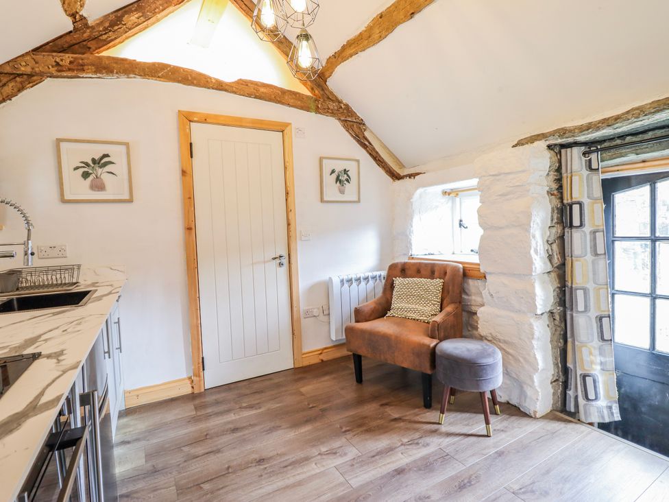 A kitchen with a sink and a chair at The Romantic Hideaway at Rhiw Goch Inn, Snowdonia National Park