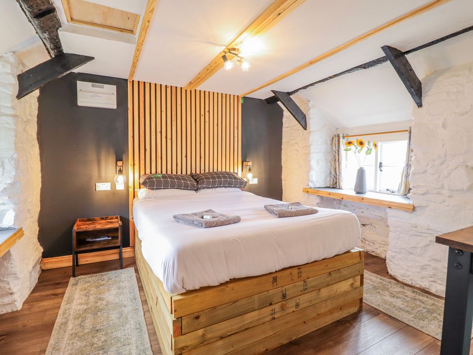 A bedroom with a bed and window at The Romantic Hideaway at Rhiw Goch Inn Snowdonia National Park