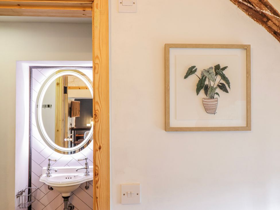 A bathroom with a sink and mirror at The Romantic Hideaway at Rhiw Goch Inn Snowdonia National Park