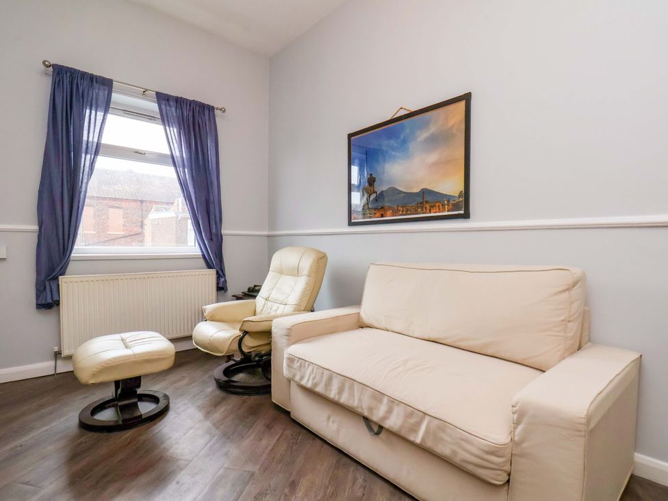 A living room with a sofa and armchair at 122B Norton Road Stockton-on-Tees