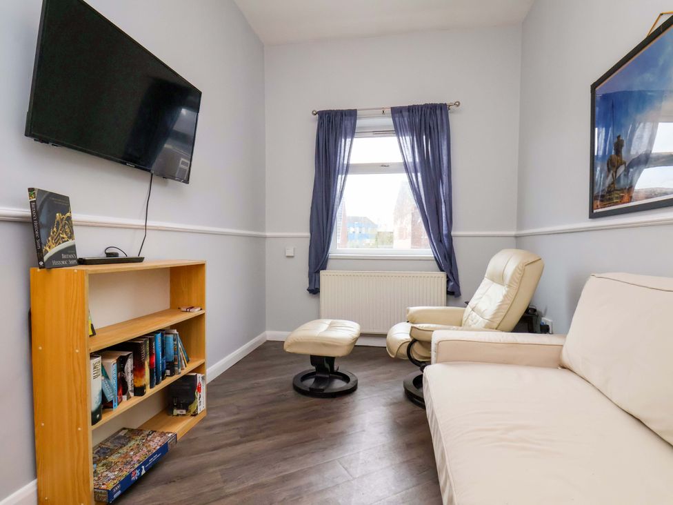 A living room with a television and bookshelf at 122B Norton Road Stockton-on-Tees