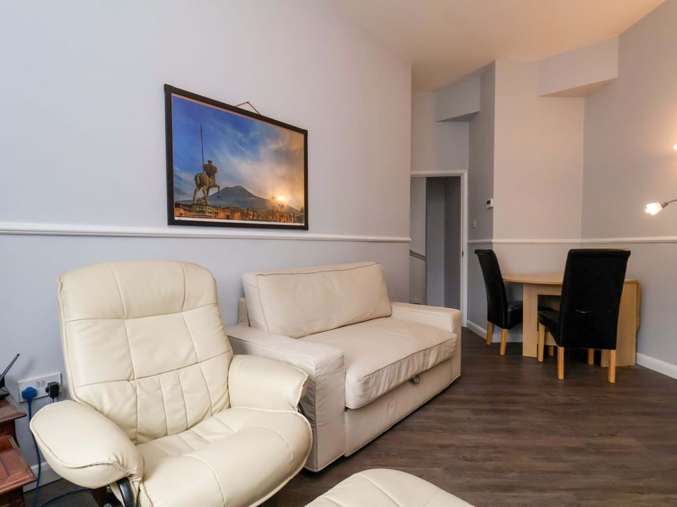 A living room with a sofa, chairs, and a dining area at 122B Norton Road Stockton-on-Tees