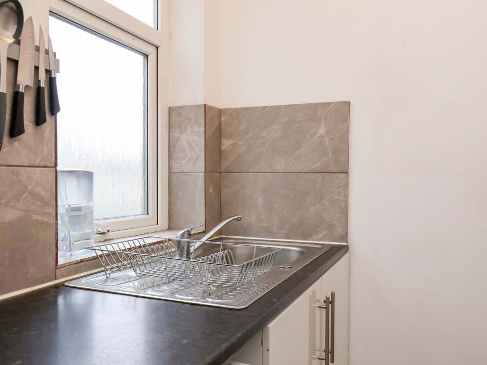 A kitchen sink with a dish rack and knives at 122B Norton Road Stockton-on-Tees