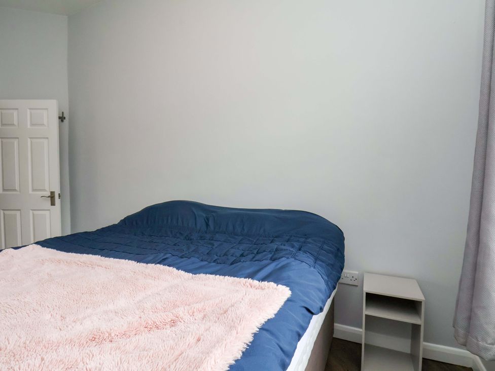 A bedroom with a bed and shelf at 122B Norton Road Stockton-on-Tees