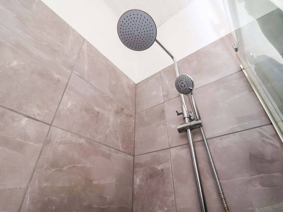 A shower with a rainfall shower head and tiled walls at 122B Norton Road Stockton-on-Tees
