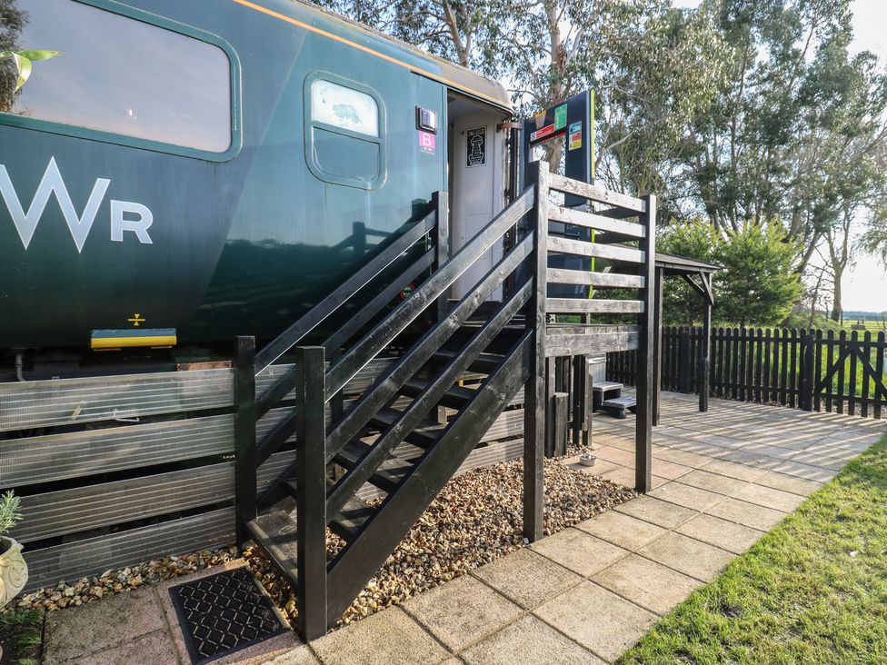 A staircase leading to a train carriage at Paddington Railway Carraige 2 with hot tub in Ely